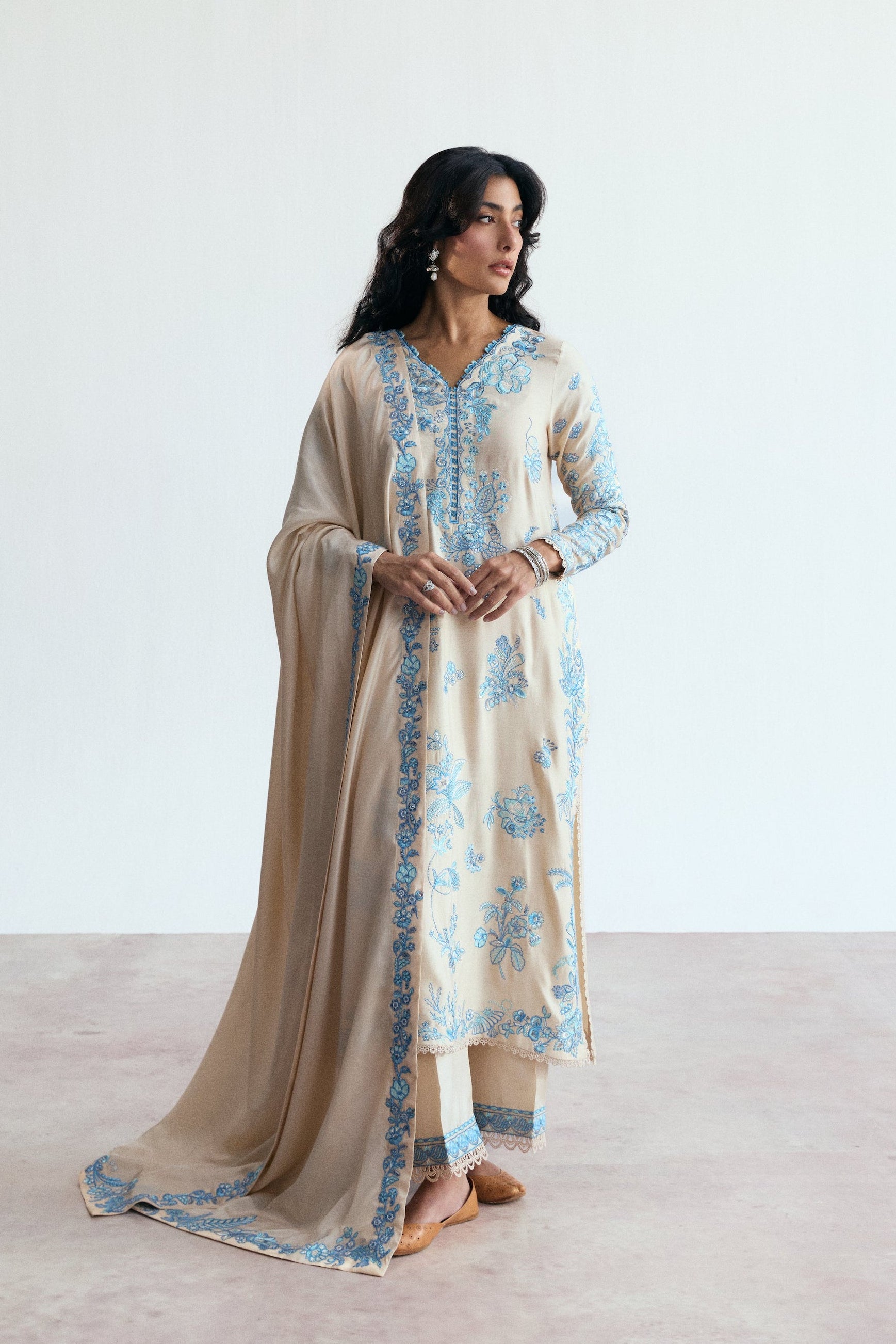 cream three piece pakistani set with blue embroidery. Semi-formal wear. 