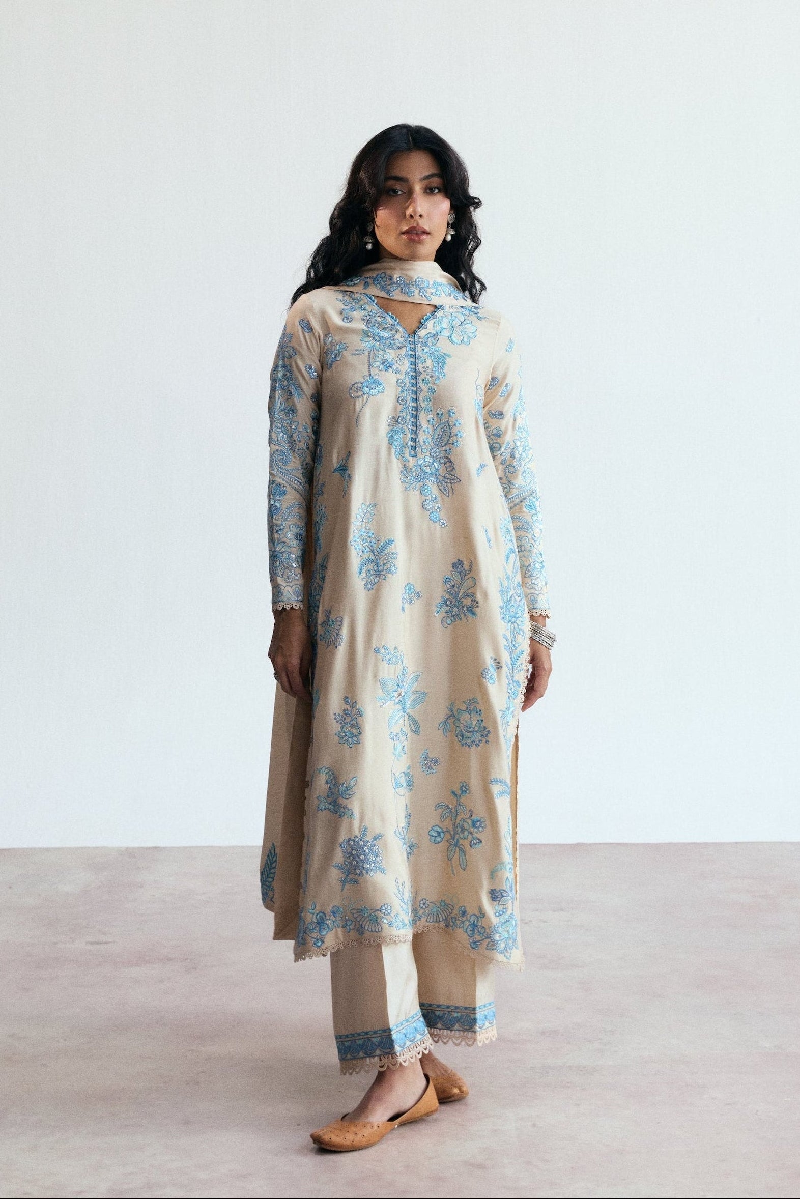 cream three piece pakistani set with blue embroidery. Semi-formal wear. 