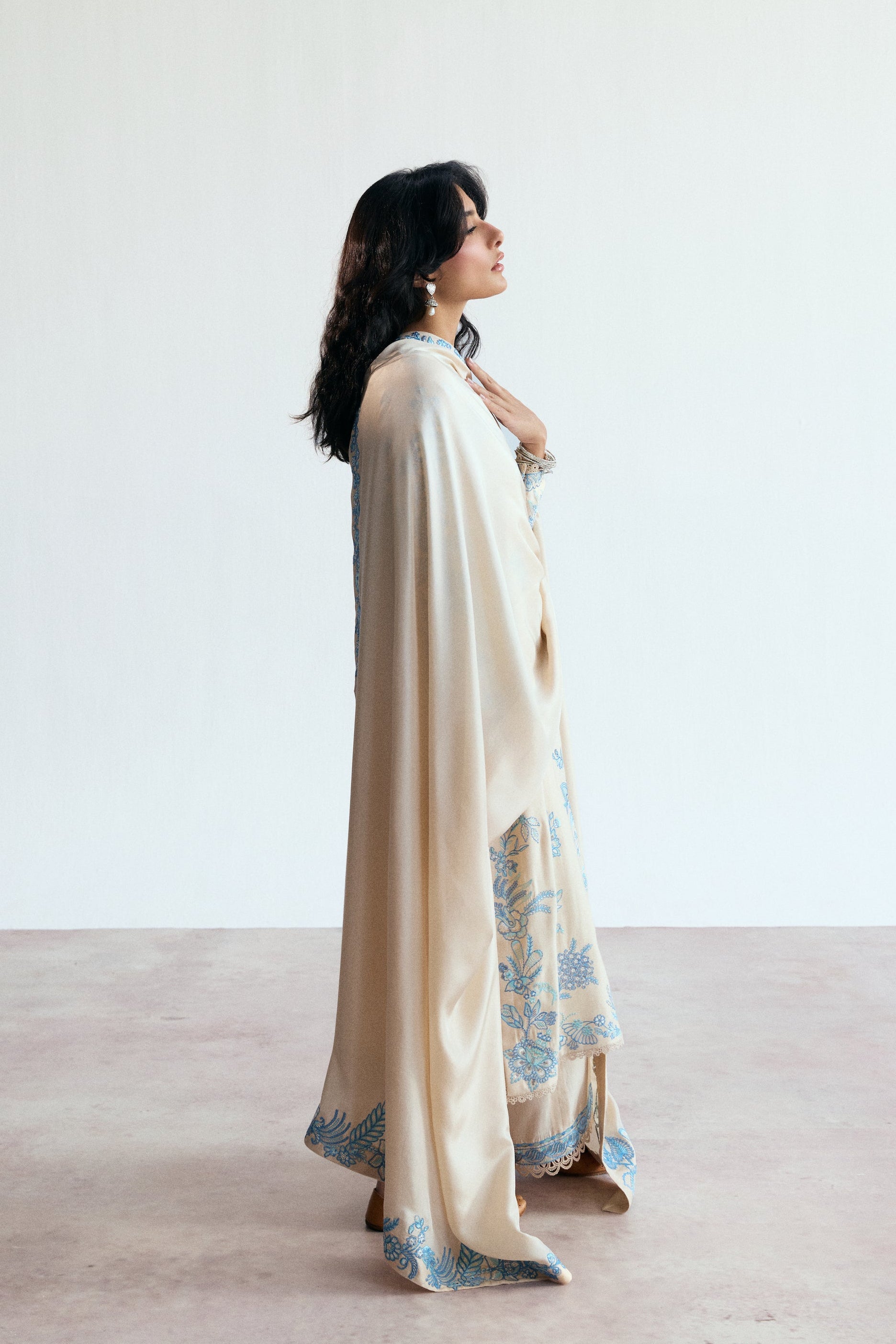 cream three piece pakistani kameez set with blue embroidery. Semi-formal wear. 