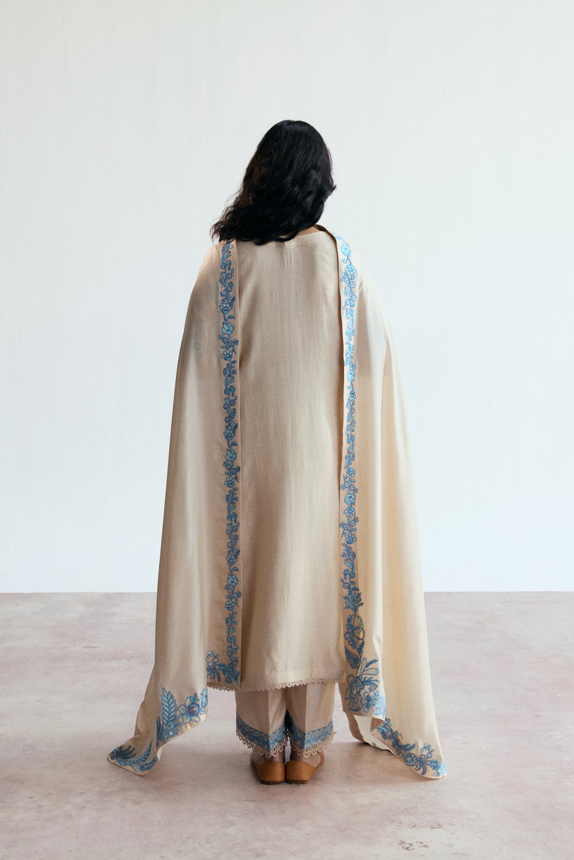 cream three piece pakistani kameez set with blue embroidery. Semi-formal wear. 