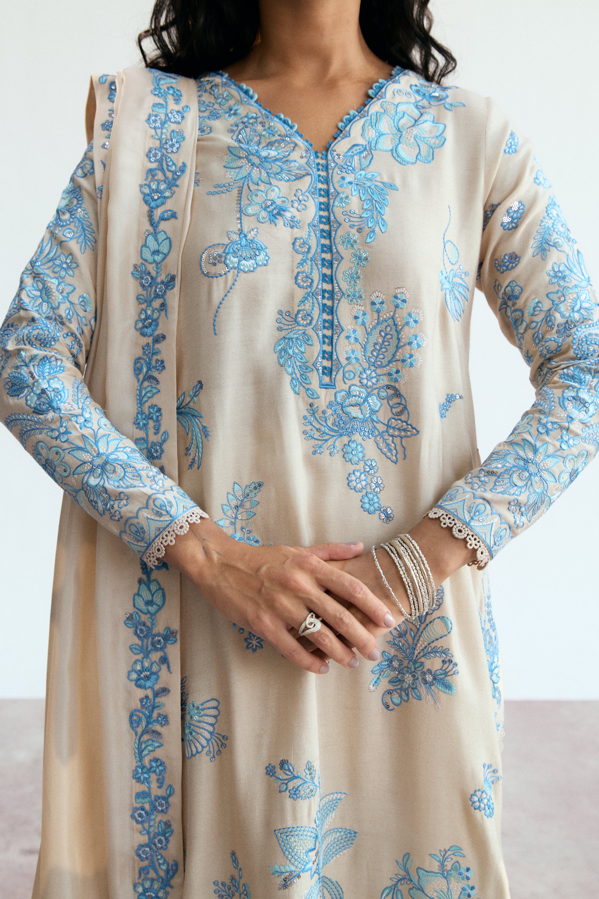 cream three piece pakistani kameez set with blue embroidery. Semi-formal wear. 
