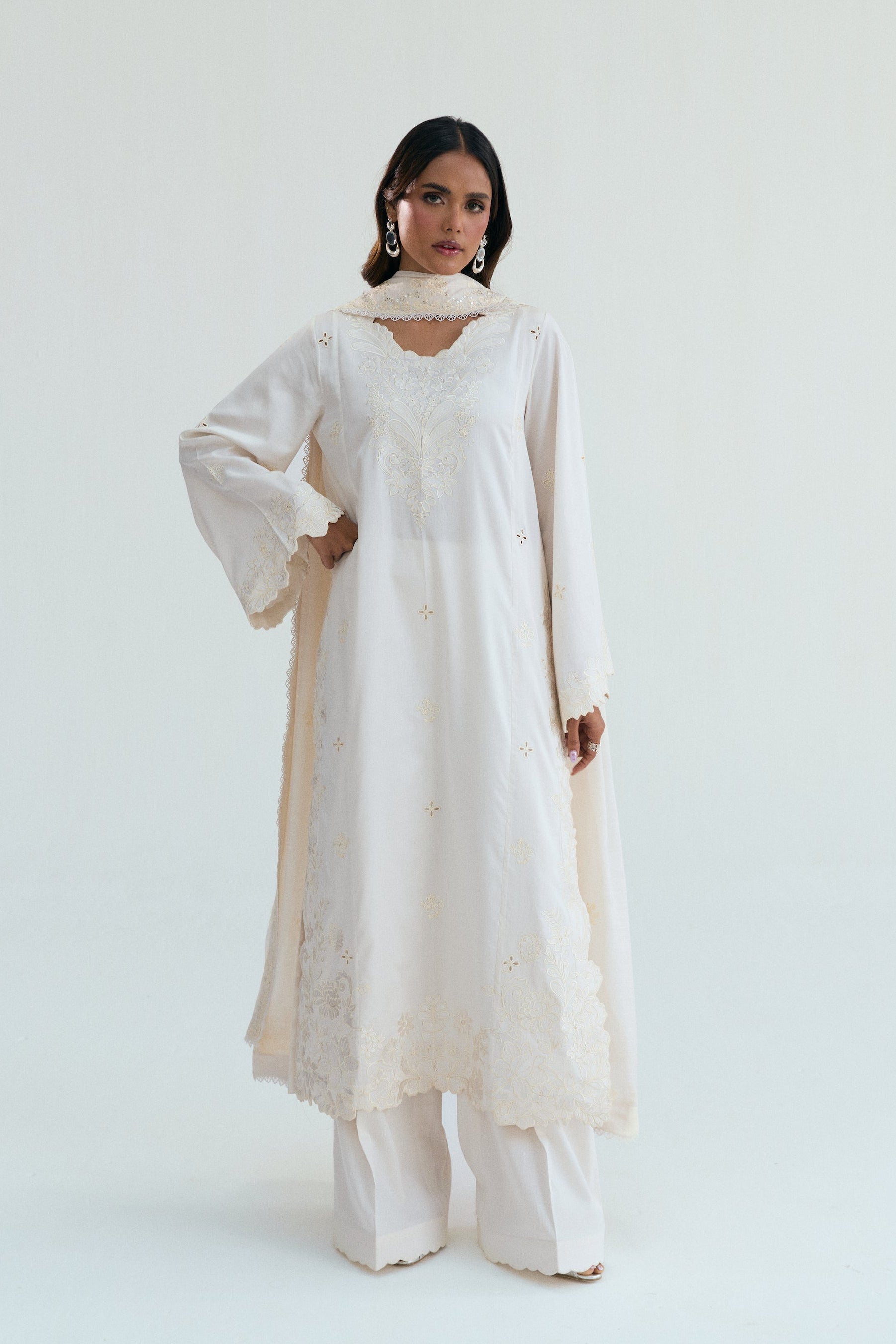  Ivory embroidered outfit with scalloped detailing, long izaar trousers,and sequin dupatta. Ideal for Eid, iftar parties and formal occasions.