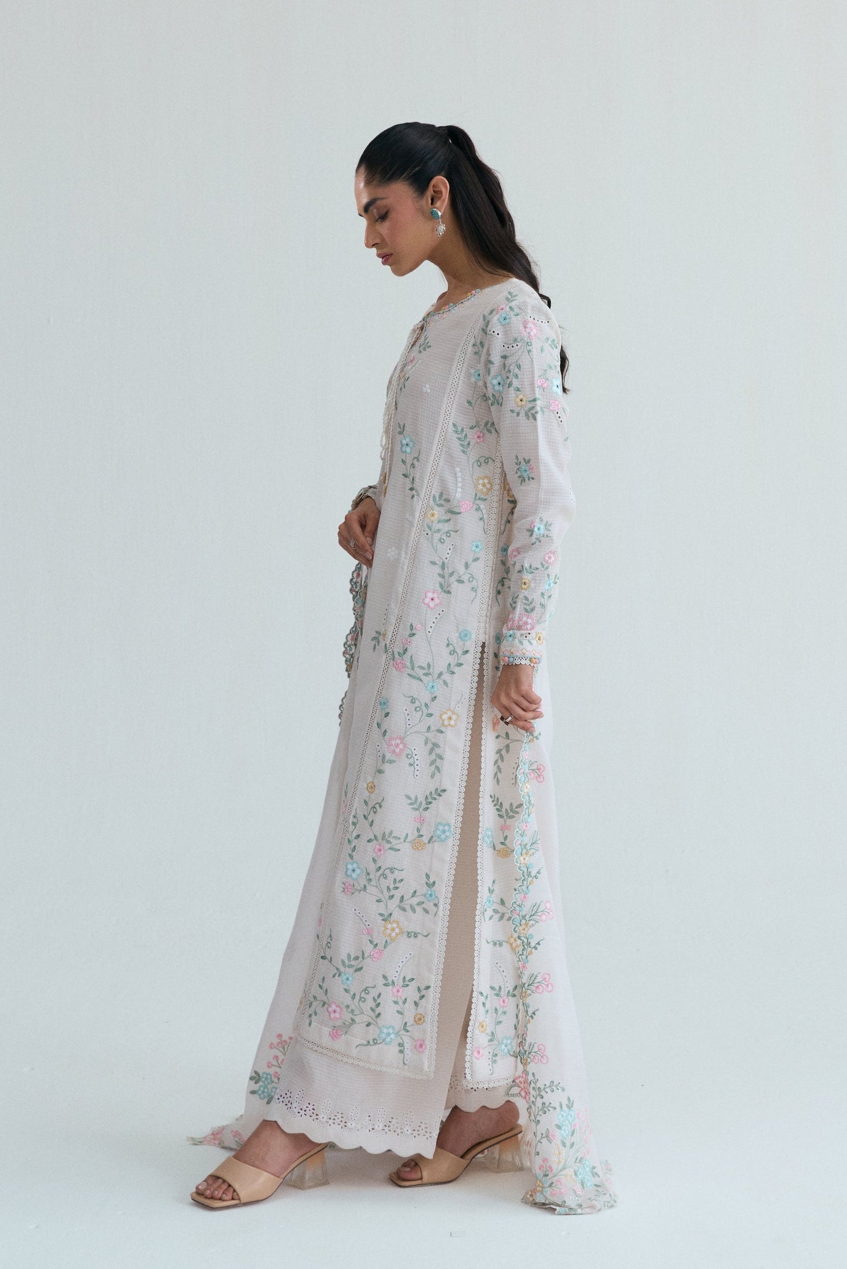 Off-white Pakistani casual wear outfit with floral embroidery, embroidered izaar trousers and scalloped dupatta. Perfect for Eid and special occasions.