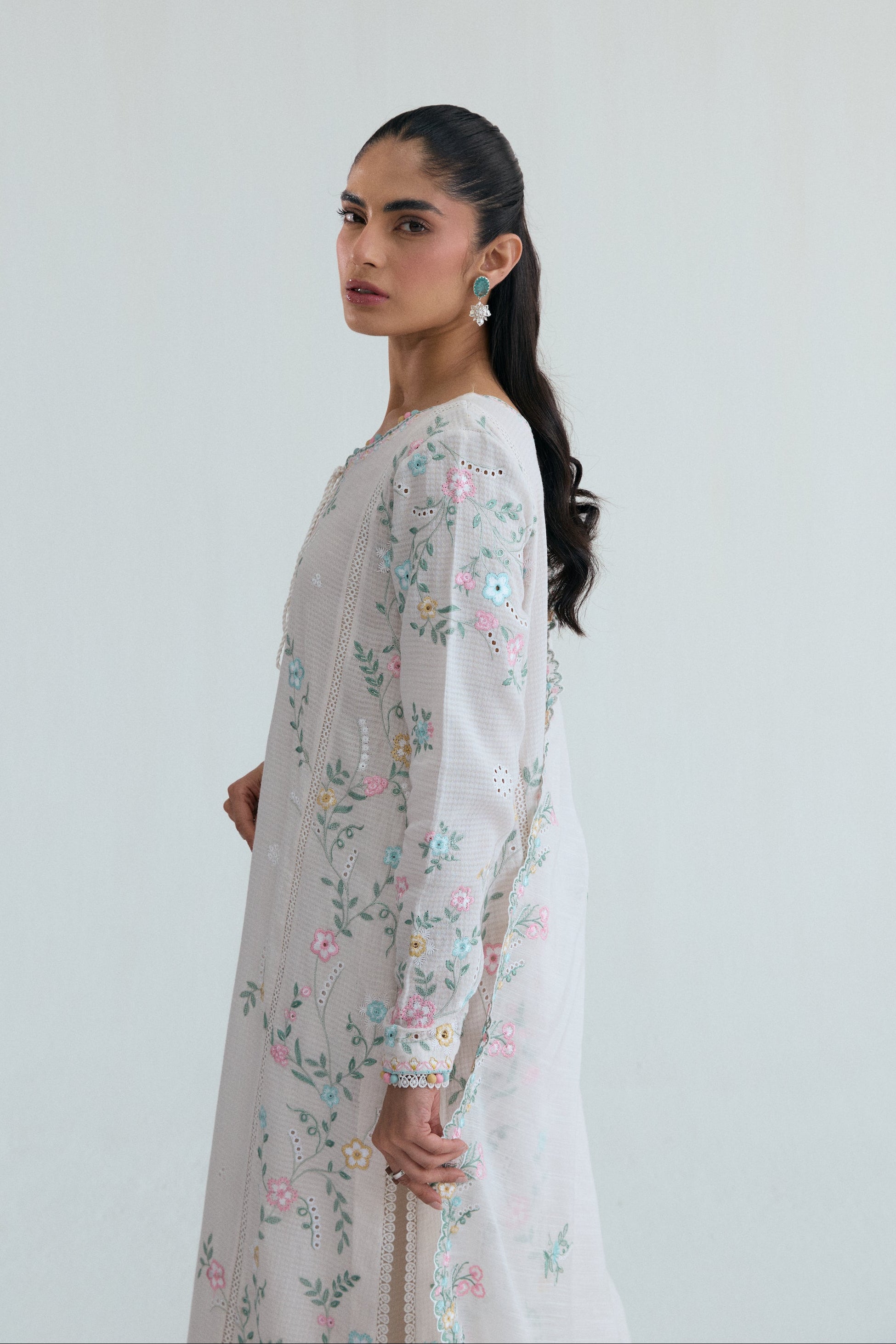 Off-white Pakistani casual wear outfit with floral embroidery, embroidered izaar trousers and scalloped dupatta. Perfect for Eid and special occasions.