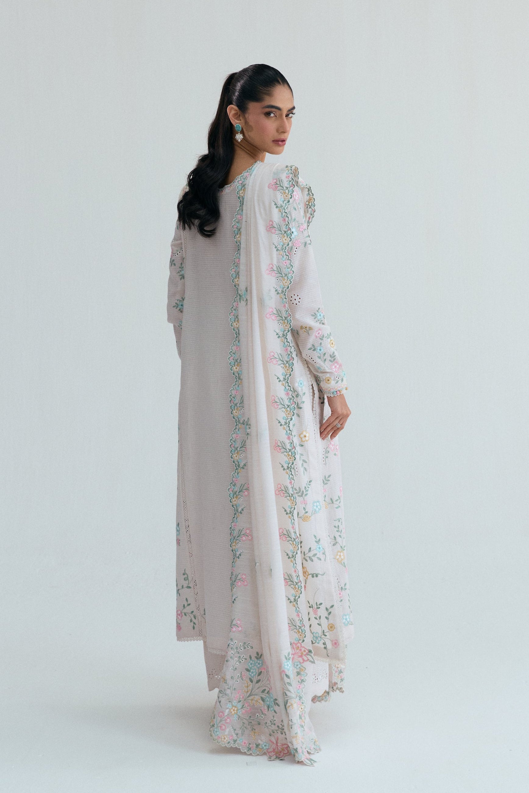 Off-white Pakistani casual wear outfit with floral embroidery, embroidered izaar trousers and scalloped dupatta. Perfect for Eid and special occasions.
