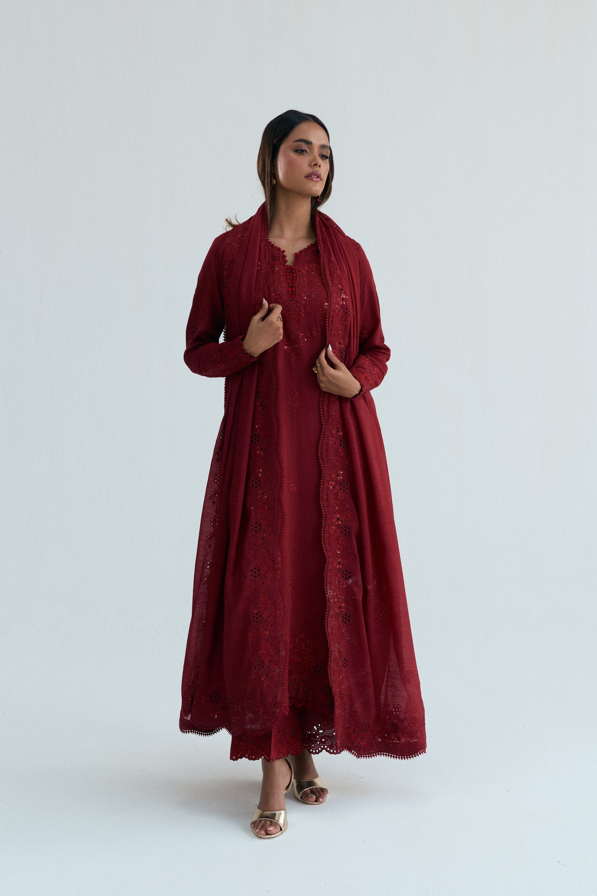 Deep red embroidered Pakistani outfit in dobby cotton with scalloped izaar trousers and slub silk dupatta. Ideal for Eid and festive occasions.