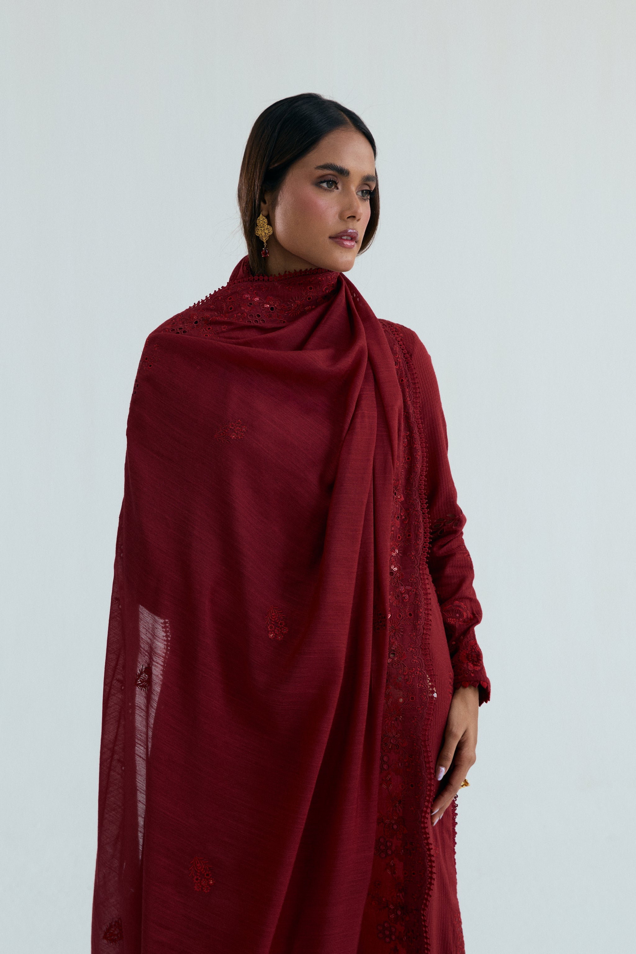 Deep red embroidered Pakistani outfit in dobby cotton with scalloped izaar trousers and slub silk dupatta. Ideal for Eid and festive occasions.