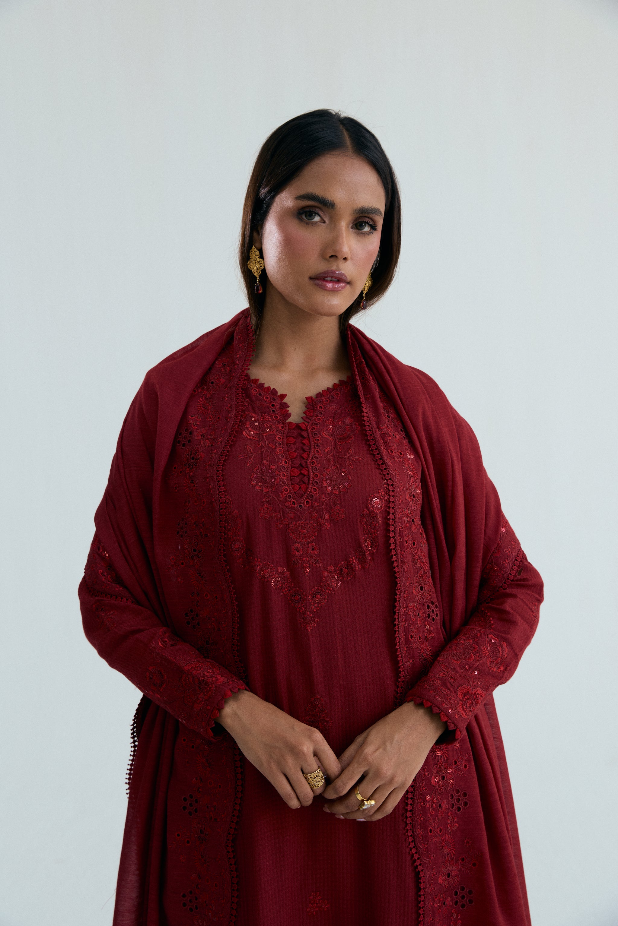 Deep red embroidered Pakistani outfit in dobby cotton with scalloped izaar trousers and slub silk dupatta. Ideal for Eid and festive occasions.