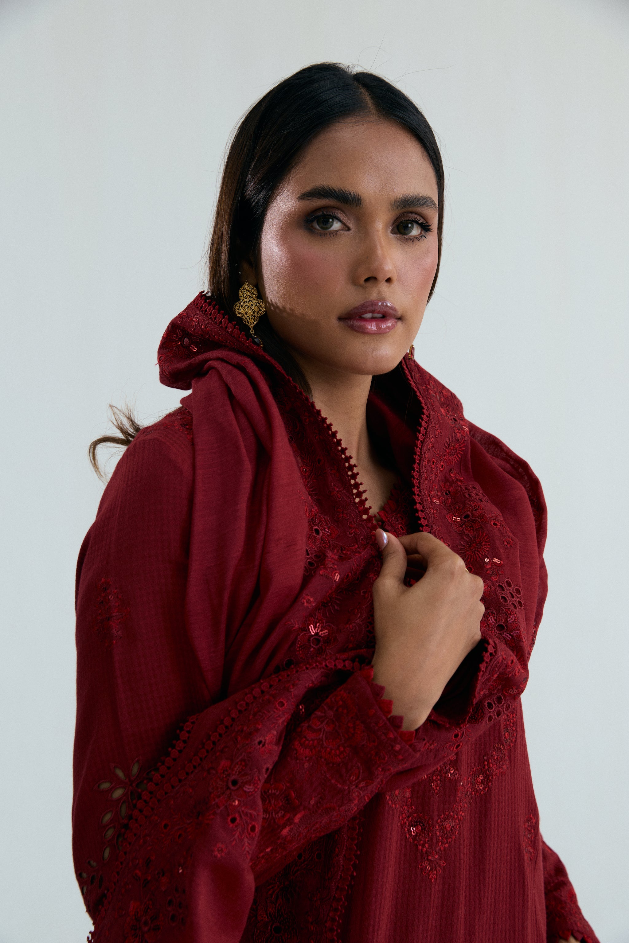 Deep red embroidered Pakistani outfit in dobby cotton with scalloped izaar trousers and slub silk dupatta. Ideal for Eid and festive occasions.