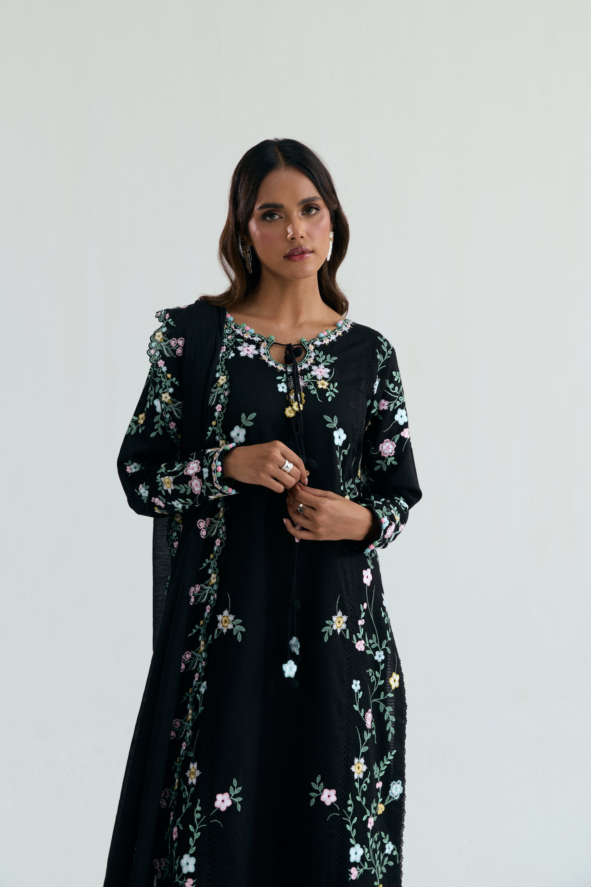  Black Pakistani casual outfit with floral embroidery, embroidered izaar trousers and scalloped dupatta. 