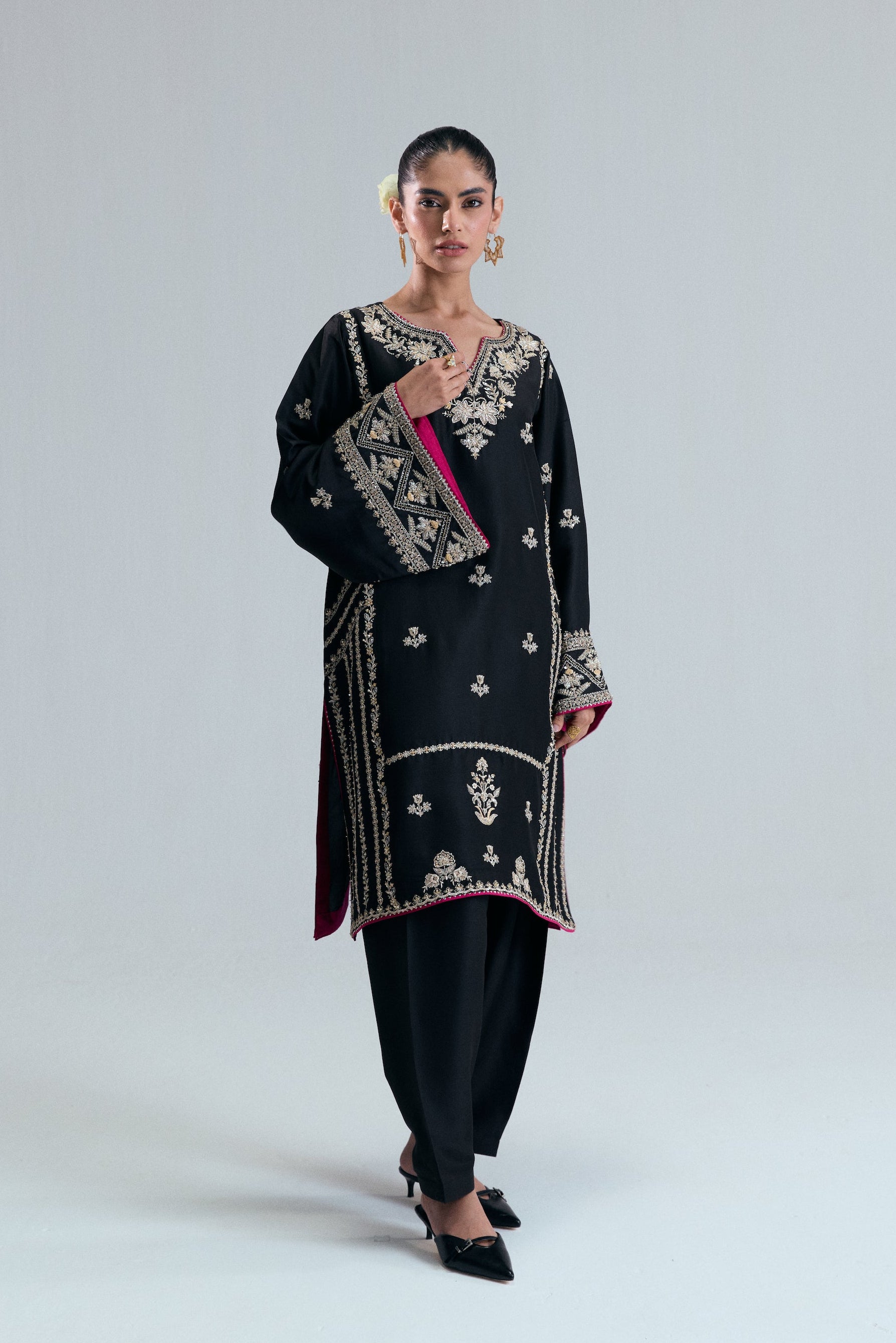 Pakistani formal wear short Phiran in black raw silk with delicate floral threadwork, beads, and metallic accents.