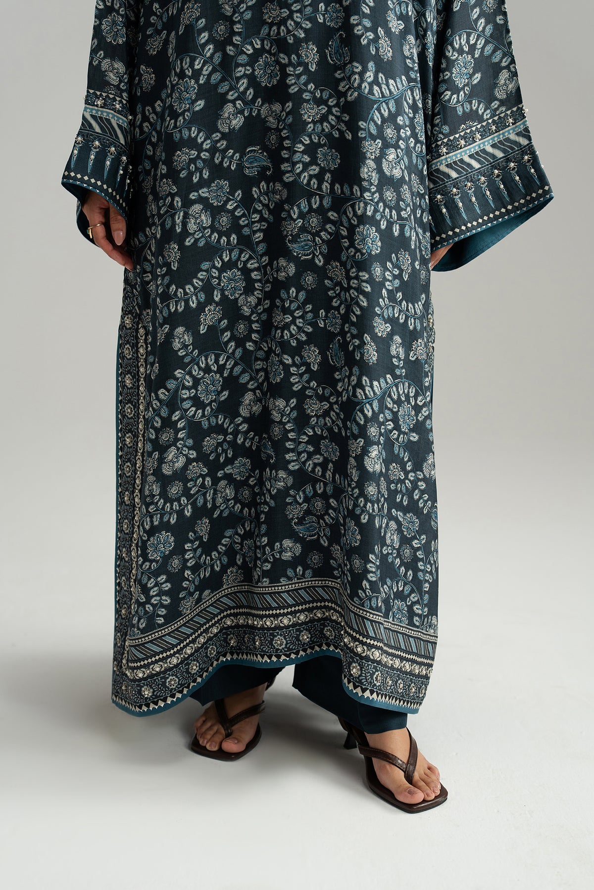 Ajrak-inspired phiran hem border and embellished sleeve cuffs over raw silk wide-leg trousers