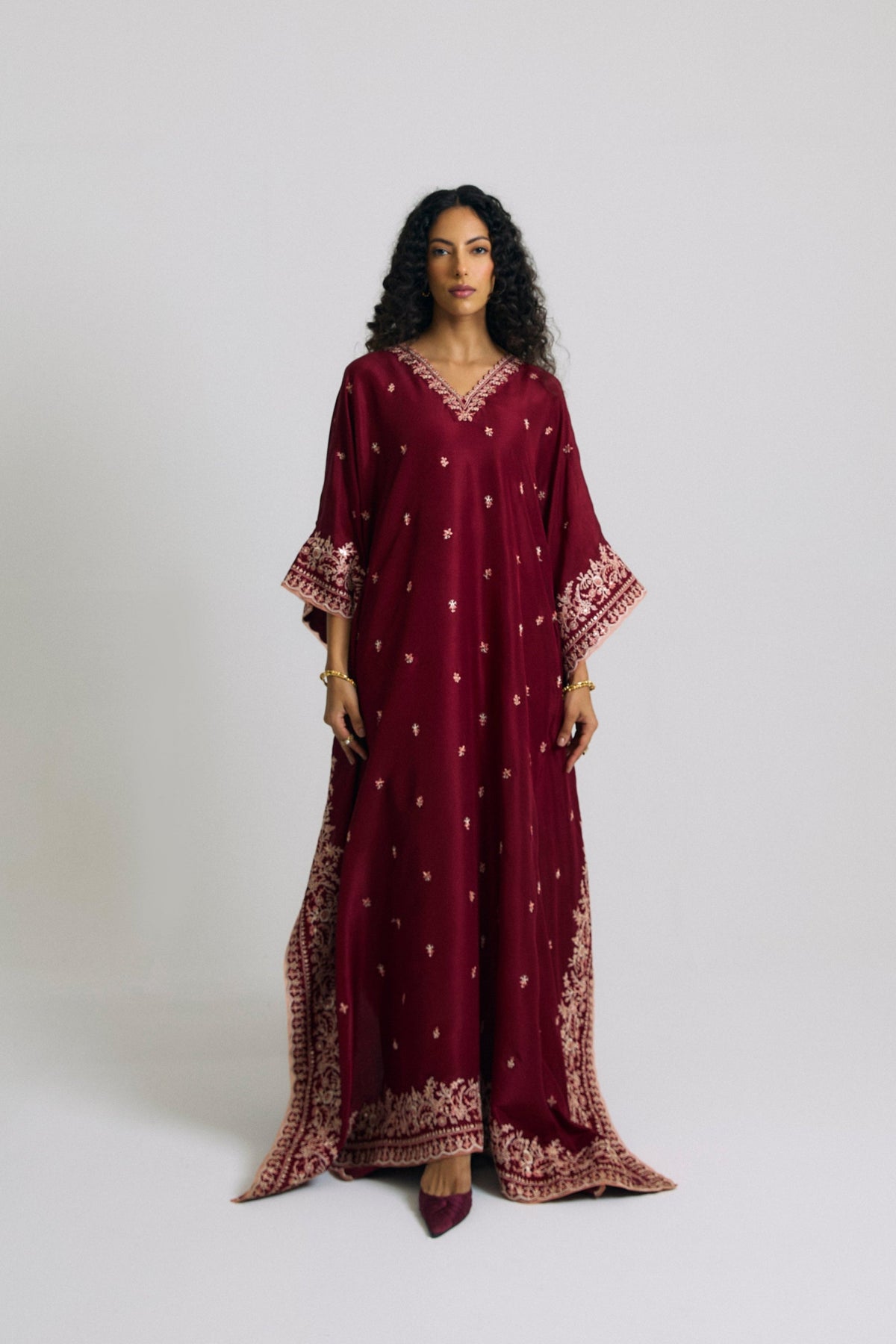 Pure silk burgundy kaftan with V-neckline, floral embroidery on sleeves and hem, full-length front view