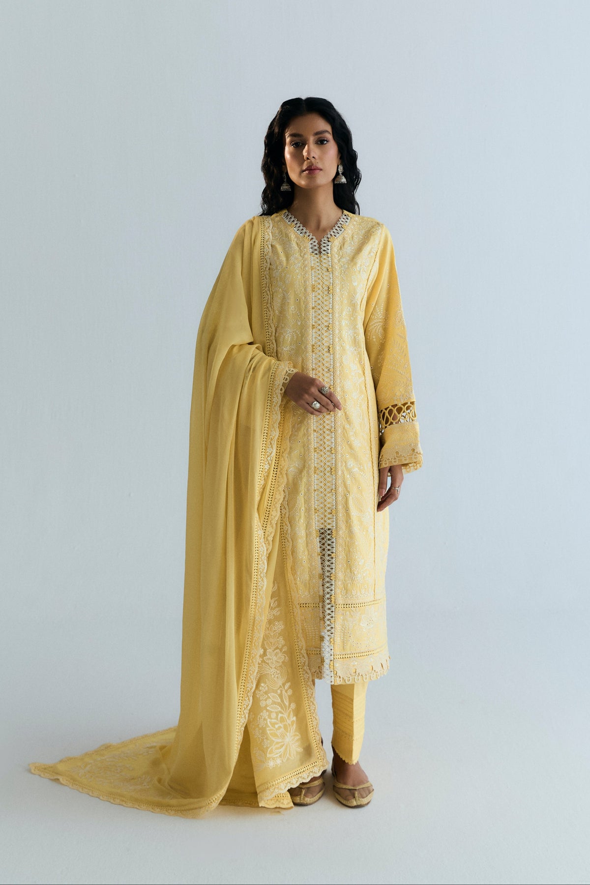 Butter yellow Pakistani suit with ivory embroidered kameez, pin-tucked trousers and georgette dupatta