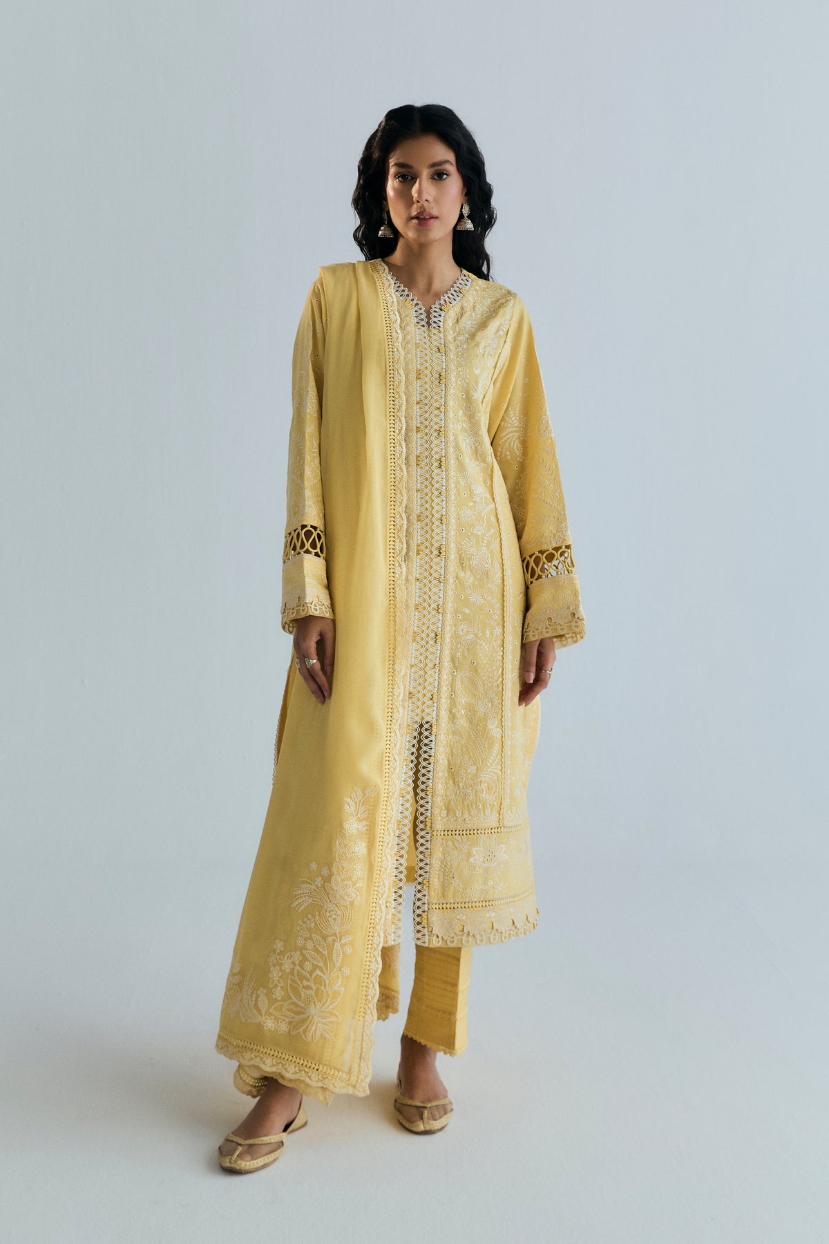 Butter yellow set styled with the embroidered dupatta draped over one shoulder, full-length front view