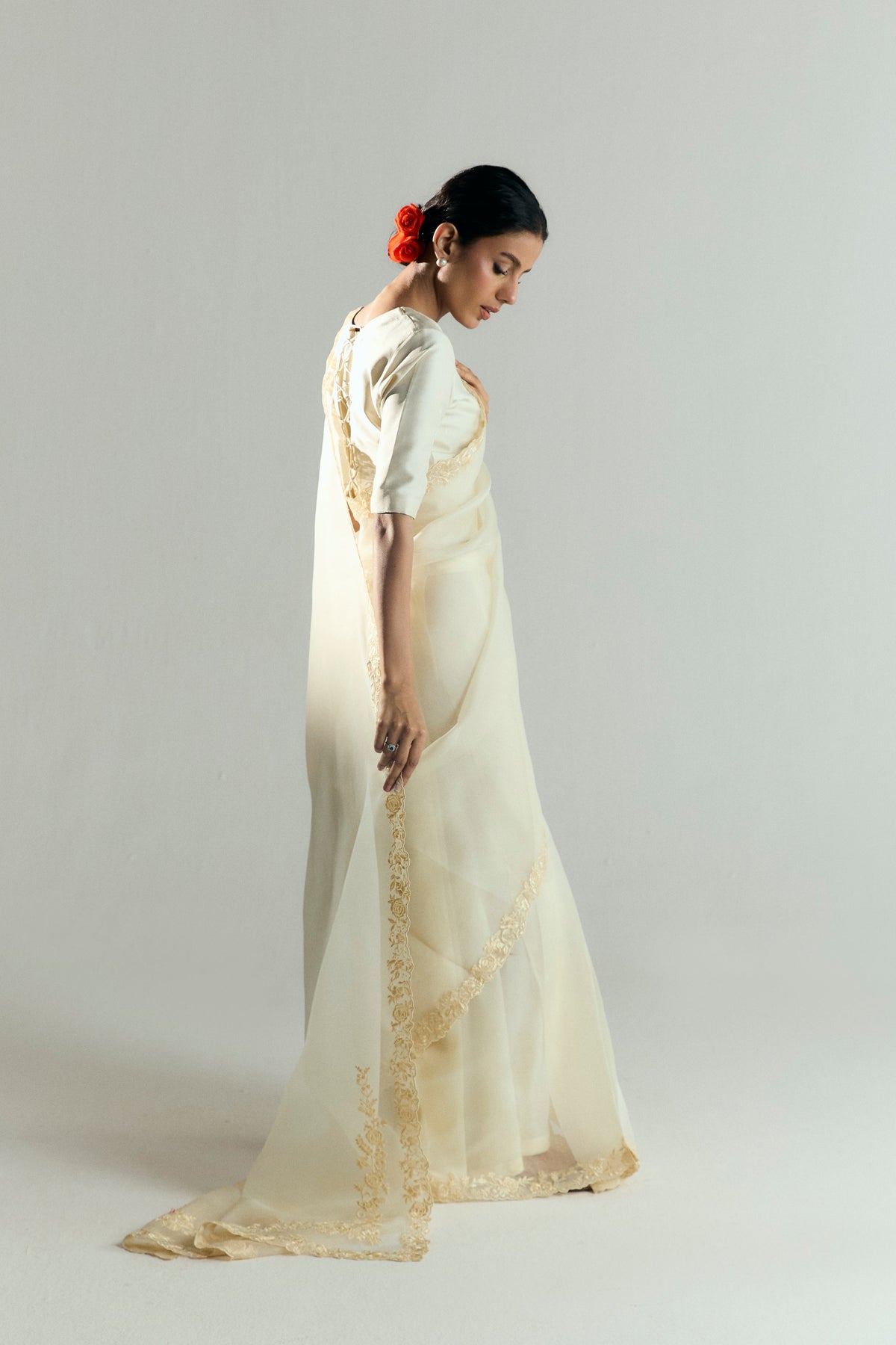 Side view of the Chantilly saree set, highlighting the flowing organza train, the extended end of the pallu and the silk blouse that ties at the back.