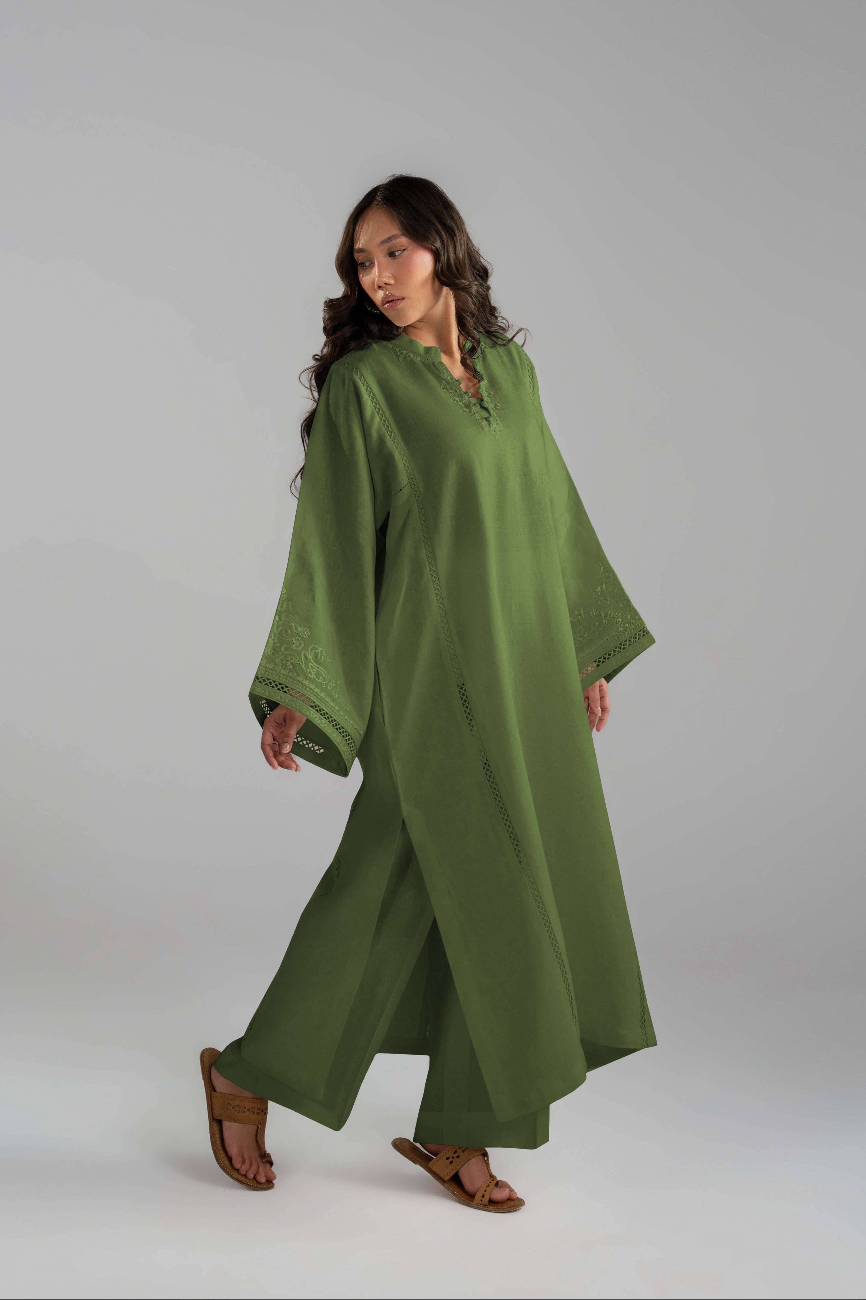 Model walking in the Clover Set, green linen tunic and trousers in motion