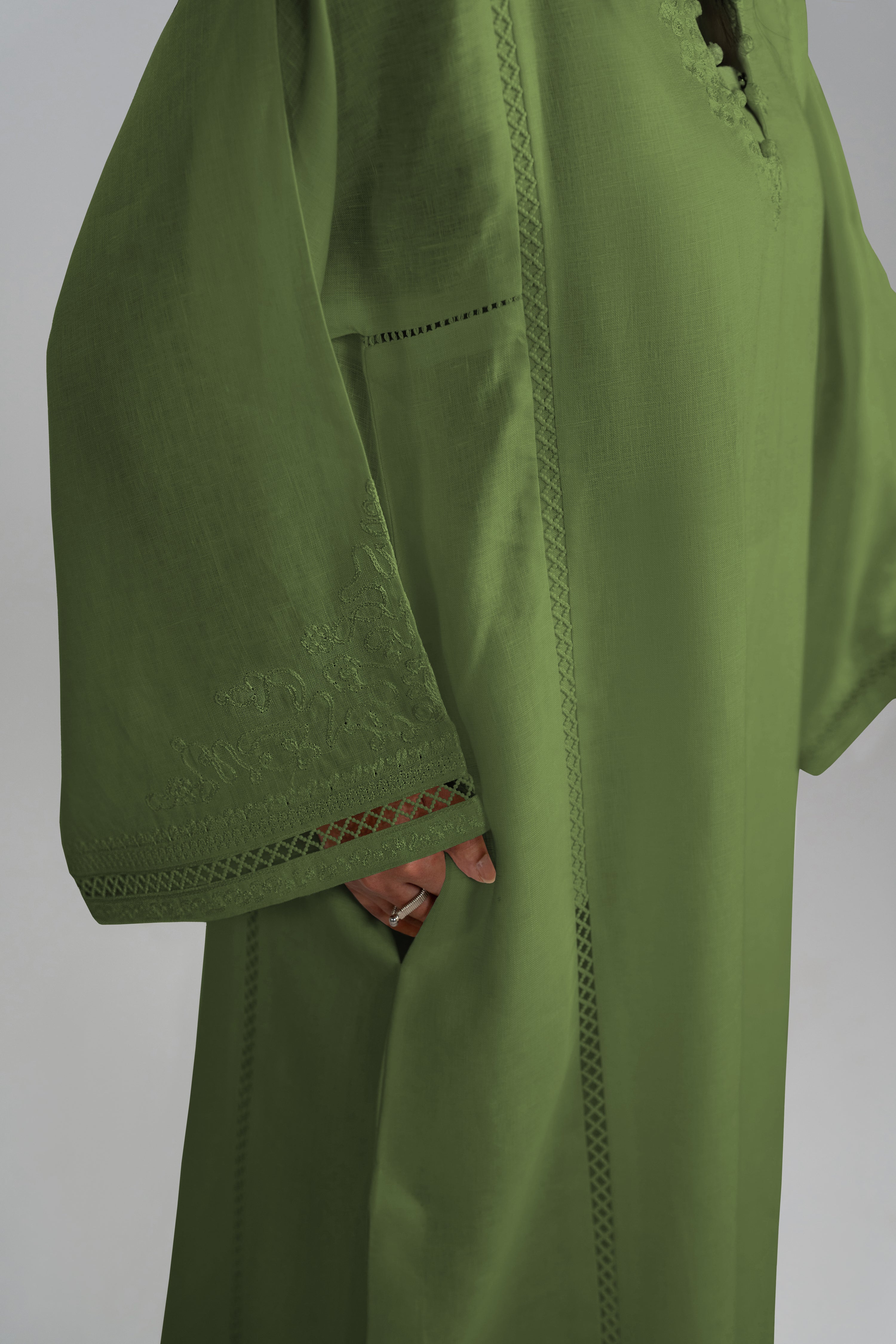 Close-up of the Clover Set side pocket detail in green linen