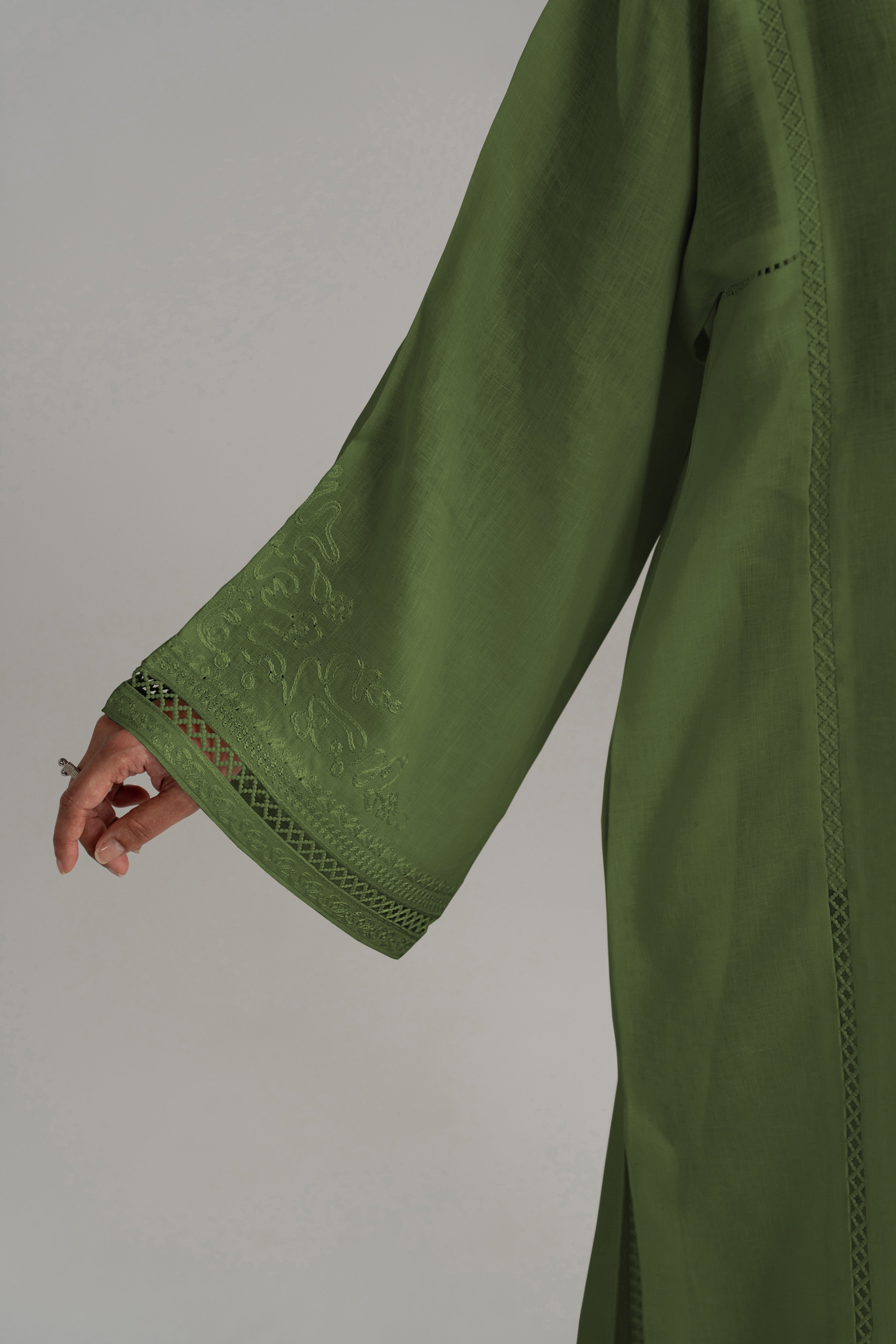 Close-up of the Clover Set's wide bell sleeve and cuff in green linen