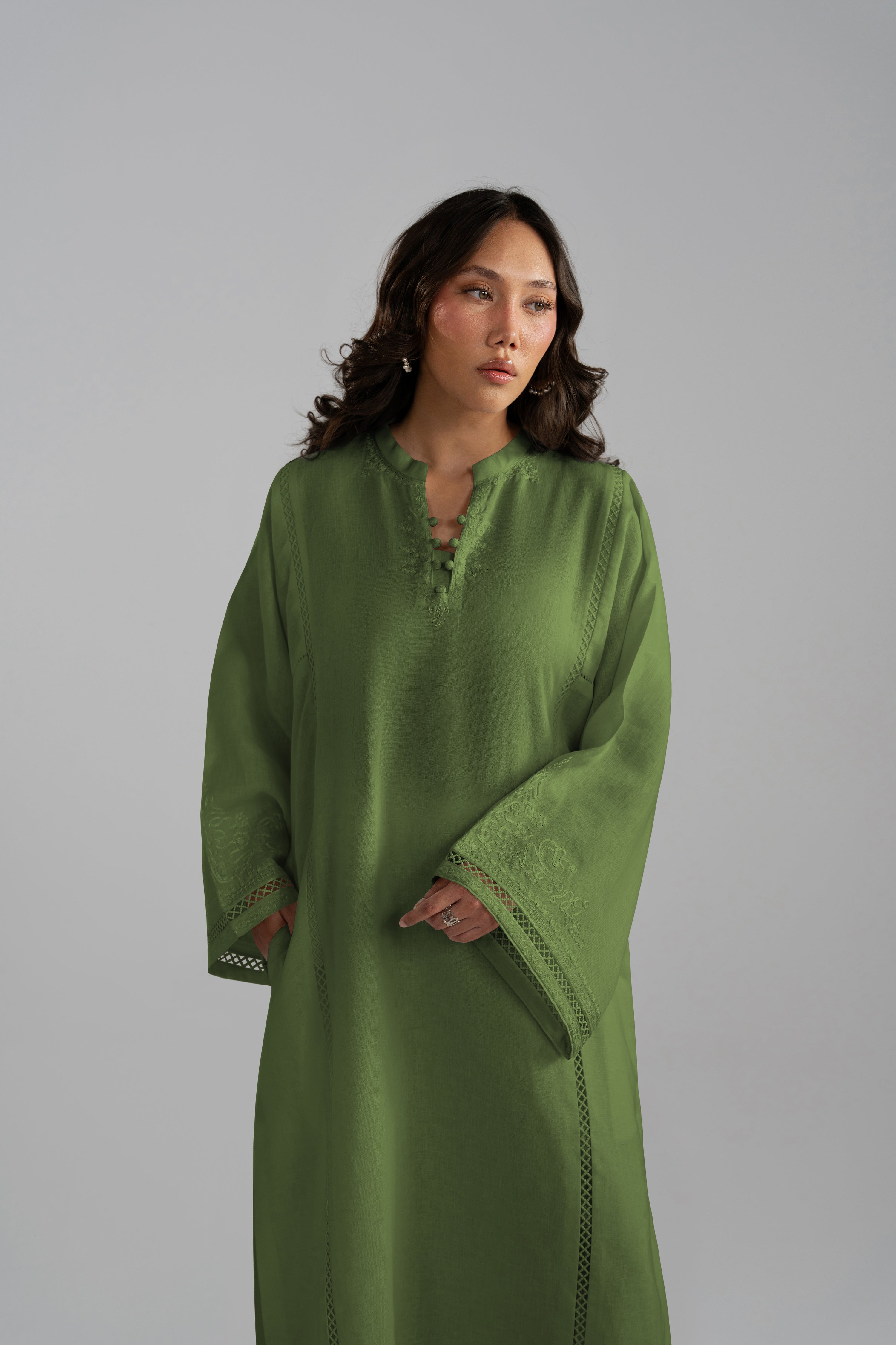 Three-quarter front view of the Clover Set in green linen with wide-hem trousers