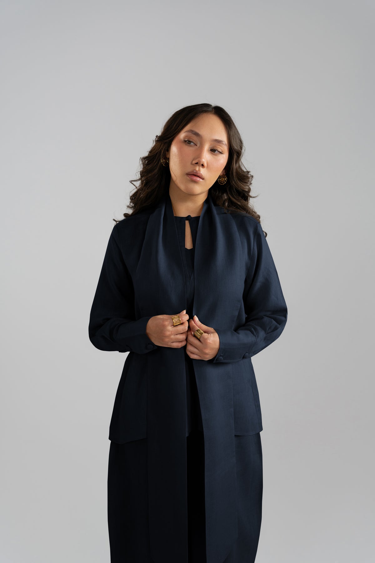 Front close-up view of the Cove Set in navy blue pure linen showing the keyhole neckline, button detailing and draped short scarf from the linen collection.