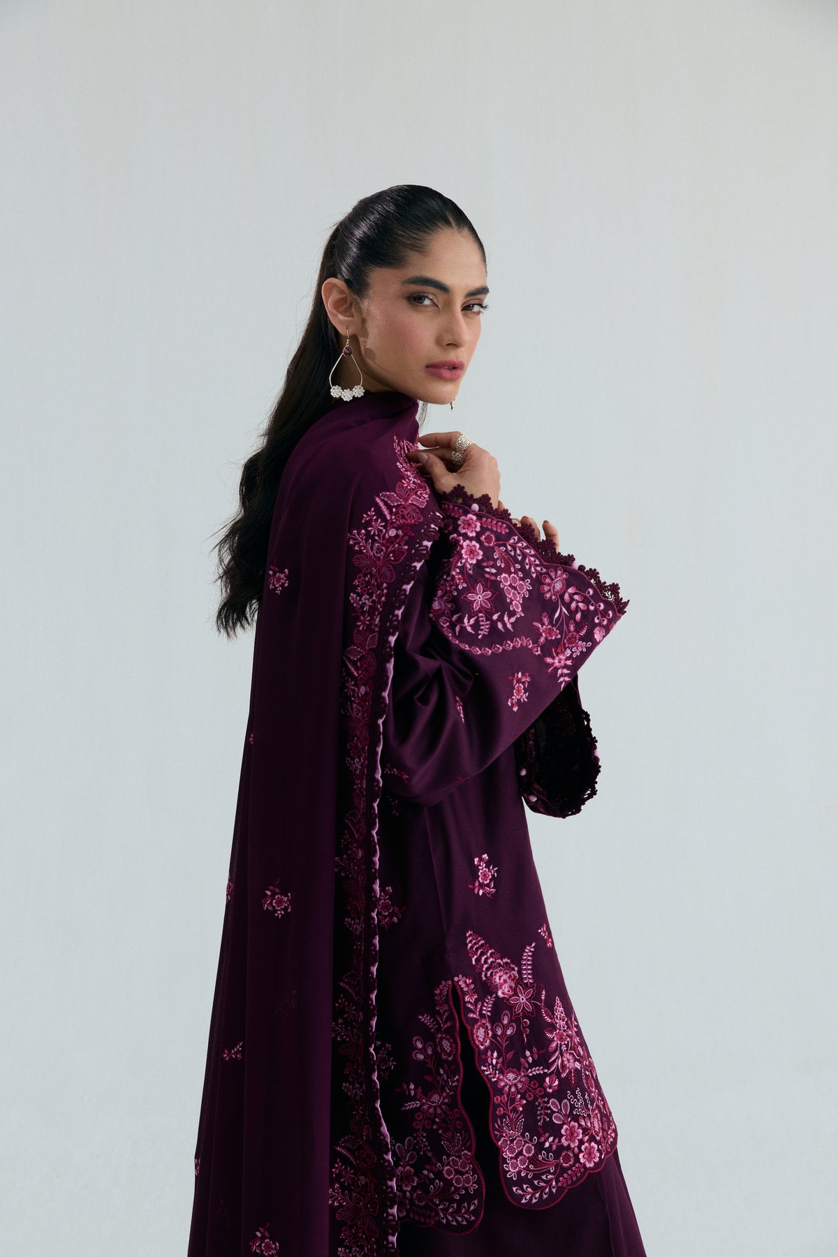 Close-up of the wide-hem sleeve, finished with floral embroidery and black lace trim