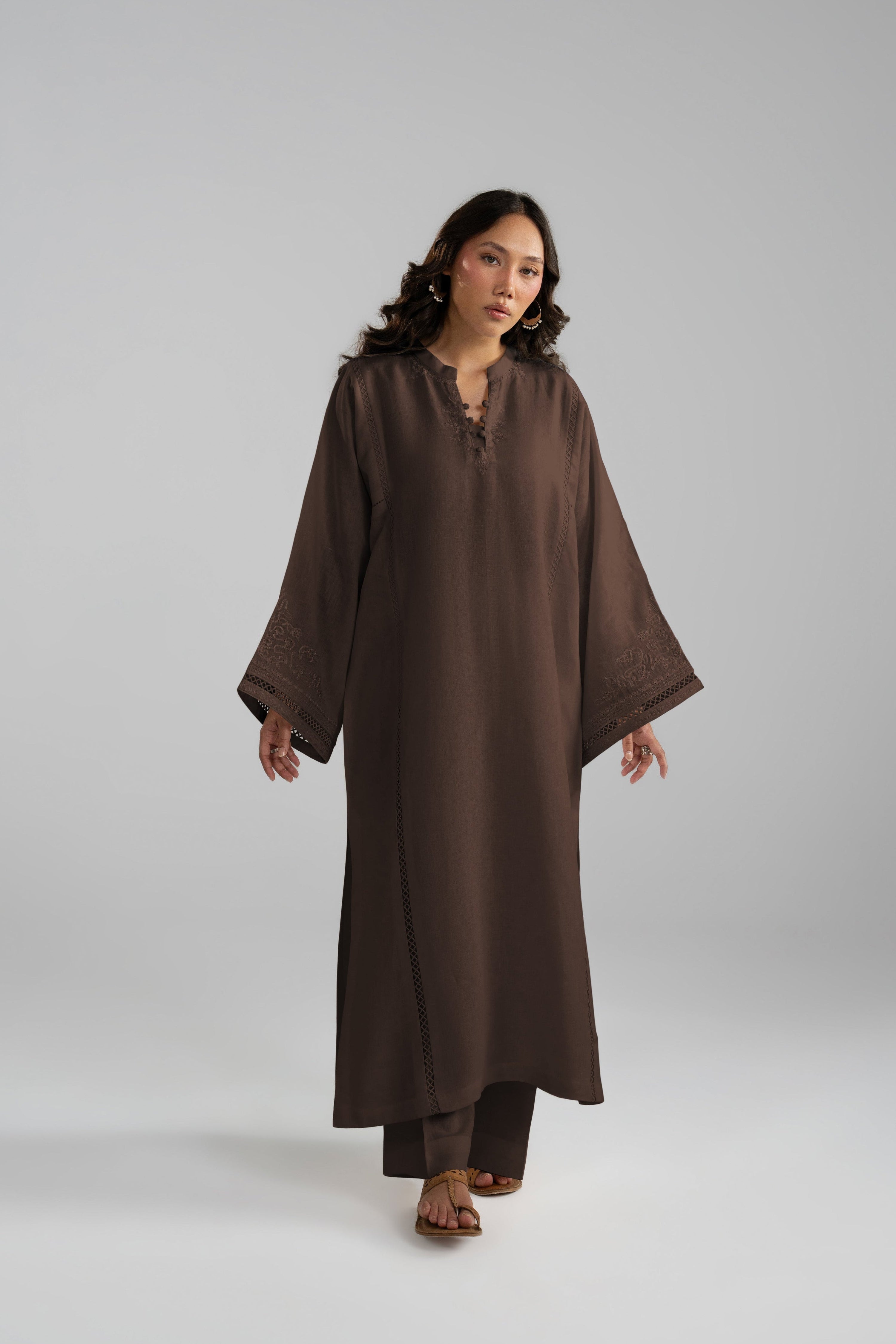 Front view of the Maple Set, a brown tunic and trouser set styled with sandals