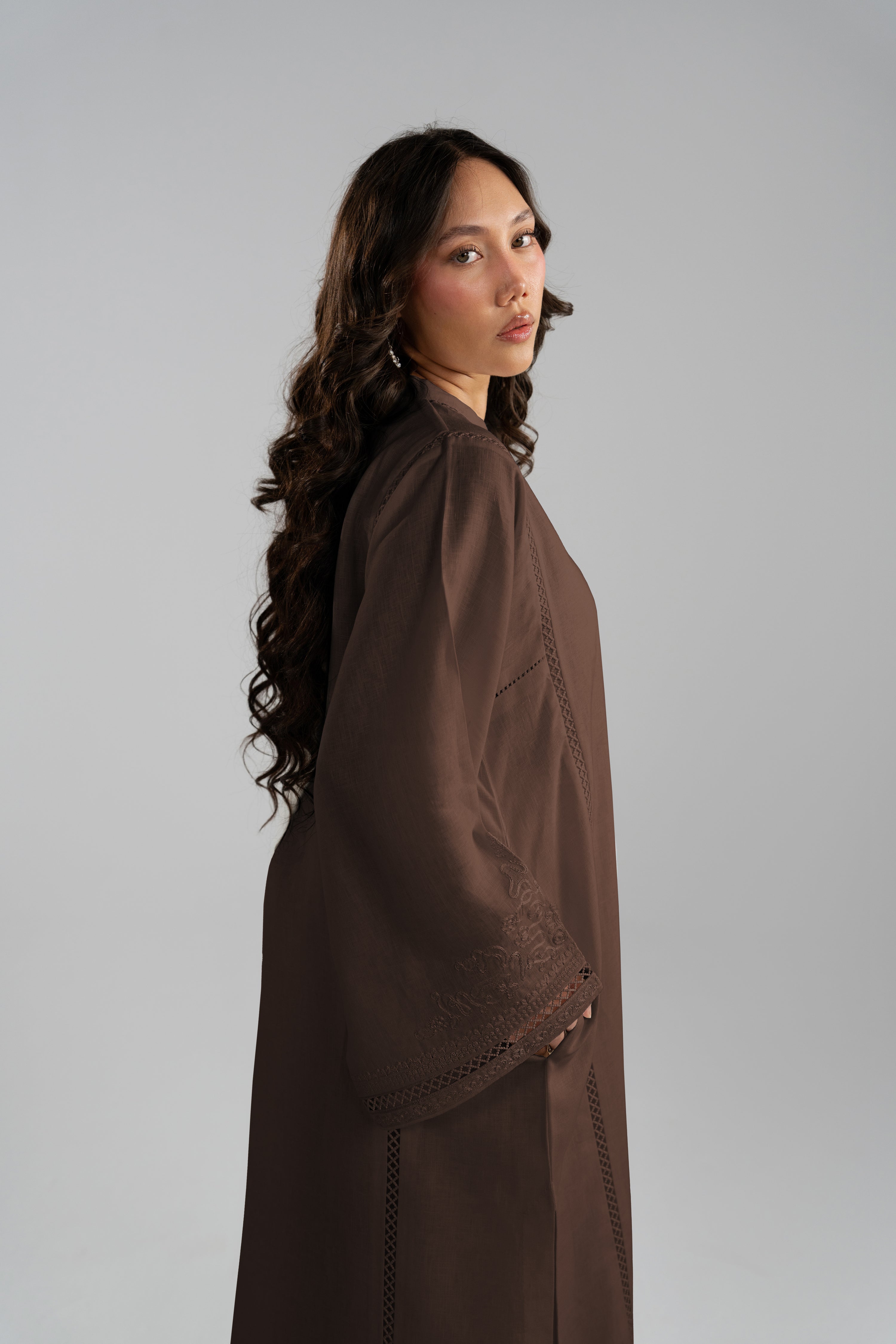 Side profile of the Maple Set showing the wide bell sleeve and flowing silhouette in brown