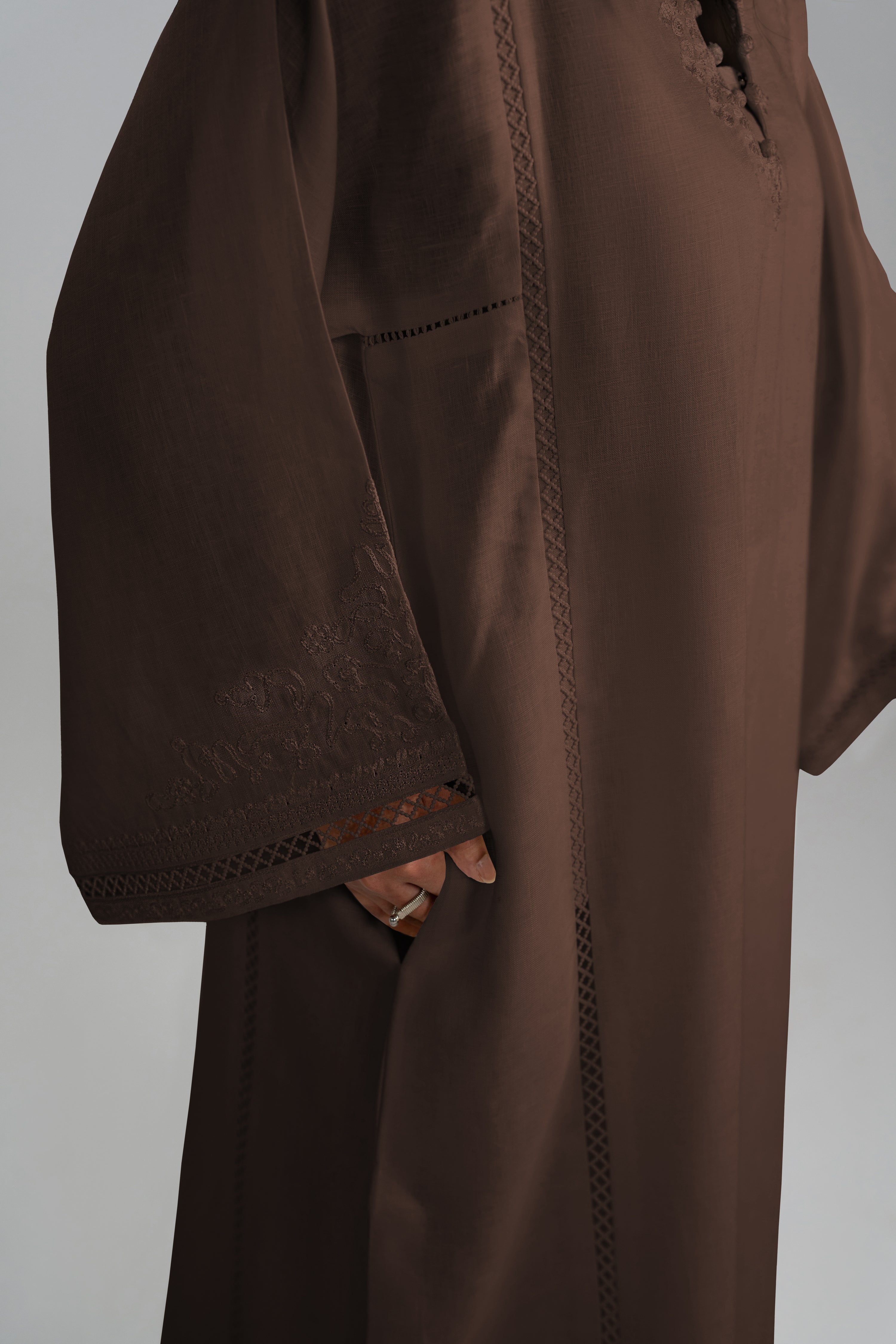 close-up of the brown Maple Set kurta showing the functional side pocket, vertical lace insert details and wide embroidered sleeves.