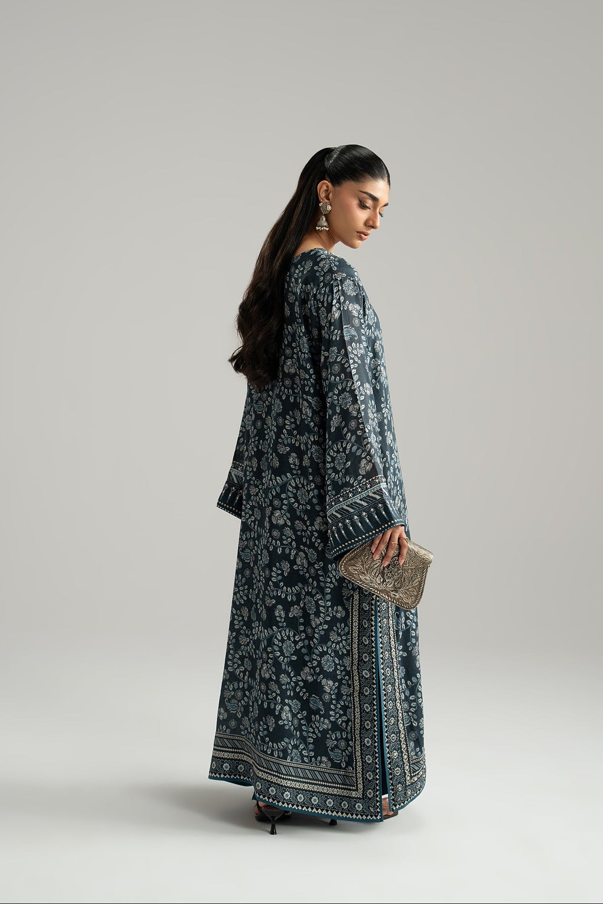 Back view of navy blue phiran suit with floral print, wide sleeve cuff and printed border hem