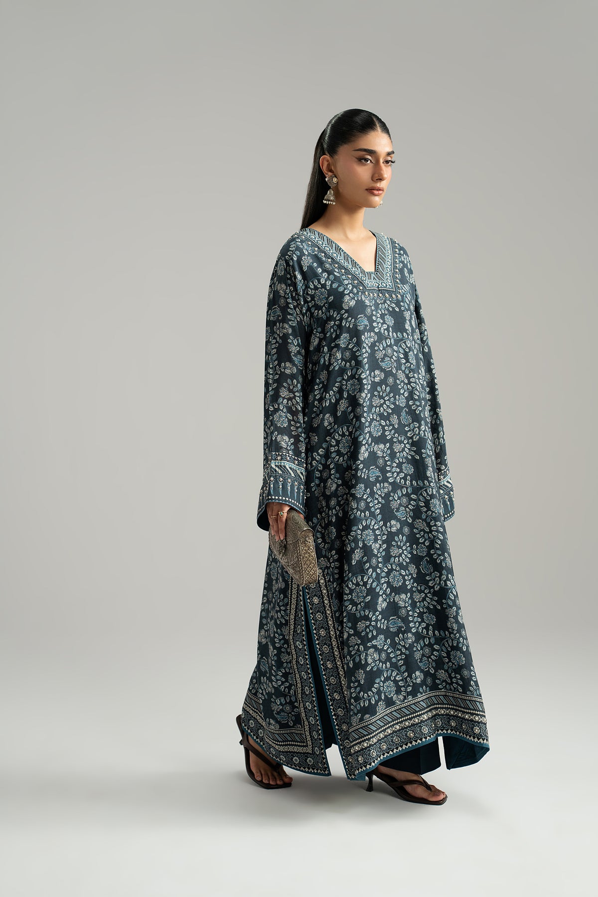 Navy blue set with silk phiran in floral print, side slit and wide-leg trousers, angled walking view