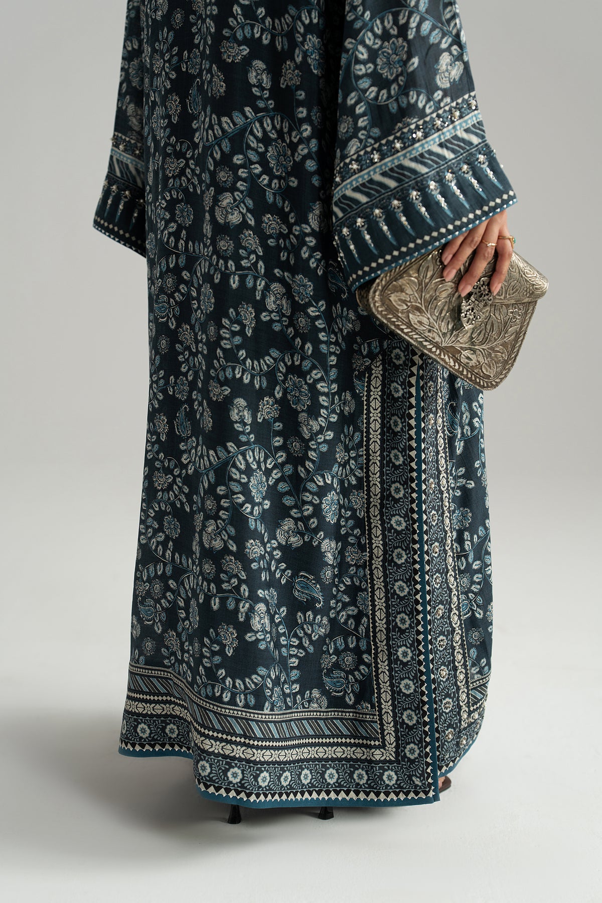 Wide phiran sleeve cuff with hand-stitched embellishment beside the printed side slit border and hem