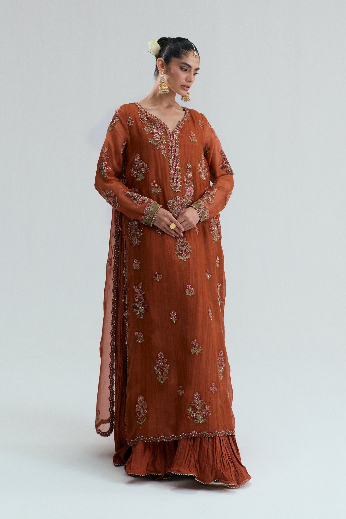 Women's rust-embroidered Pakistani suit with a long embellished shirt with a crushed flared bottom.
