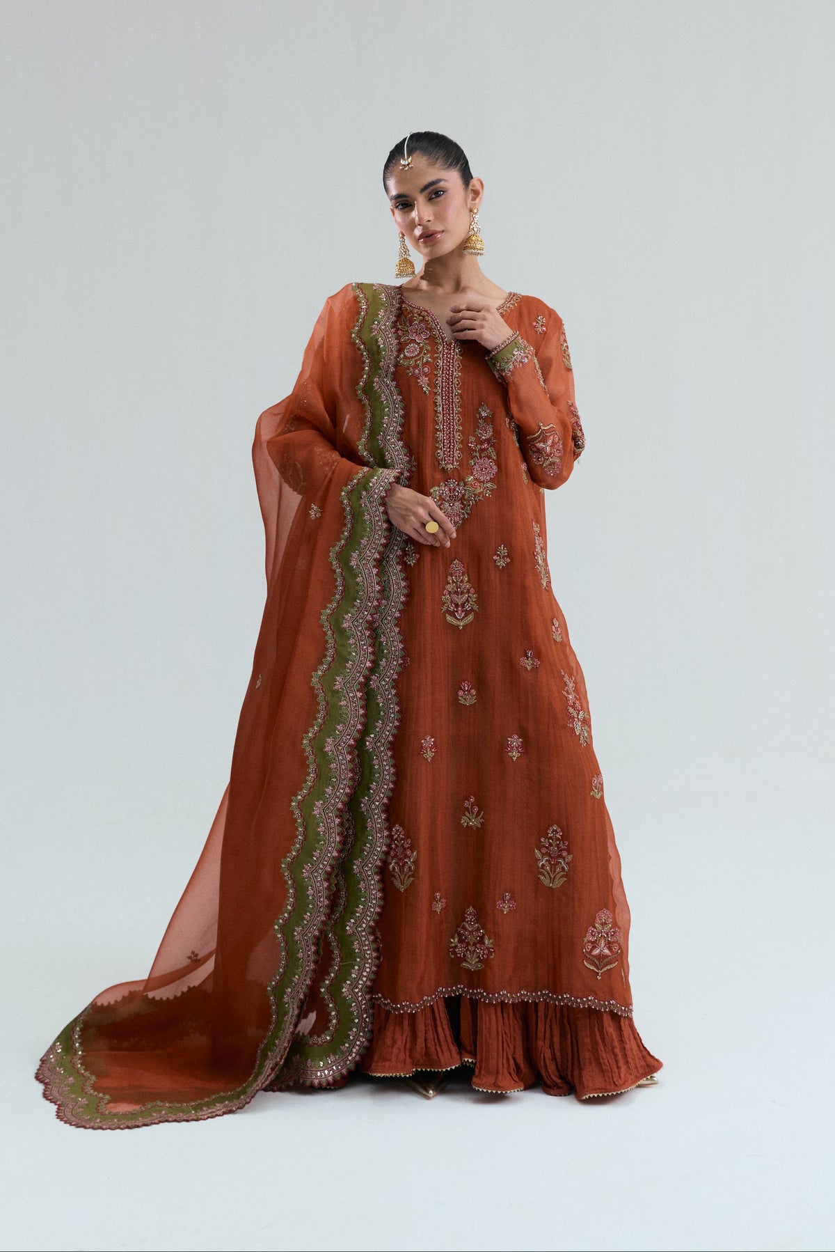 Rust orange Pakistani dress styled with the two-tone organza dupatta draped across the front