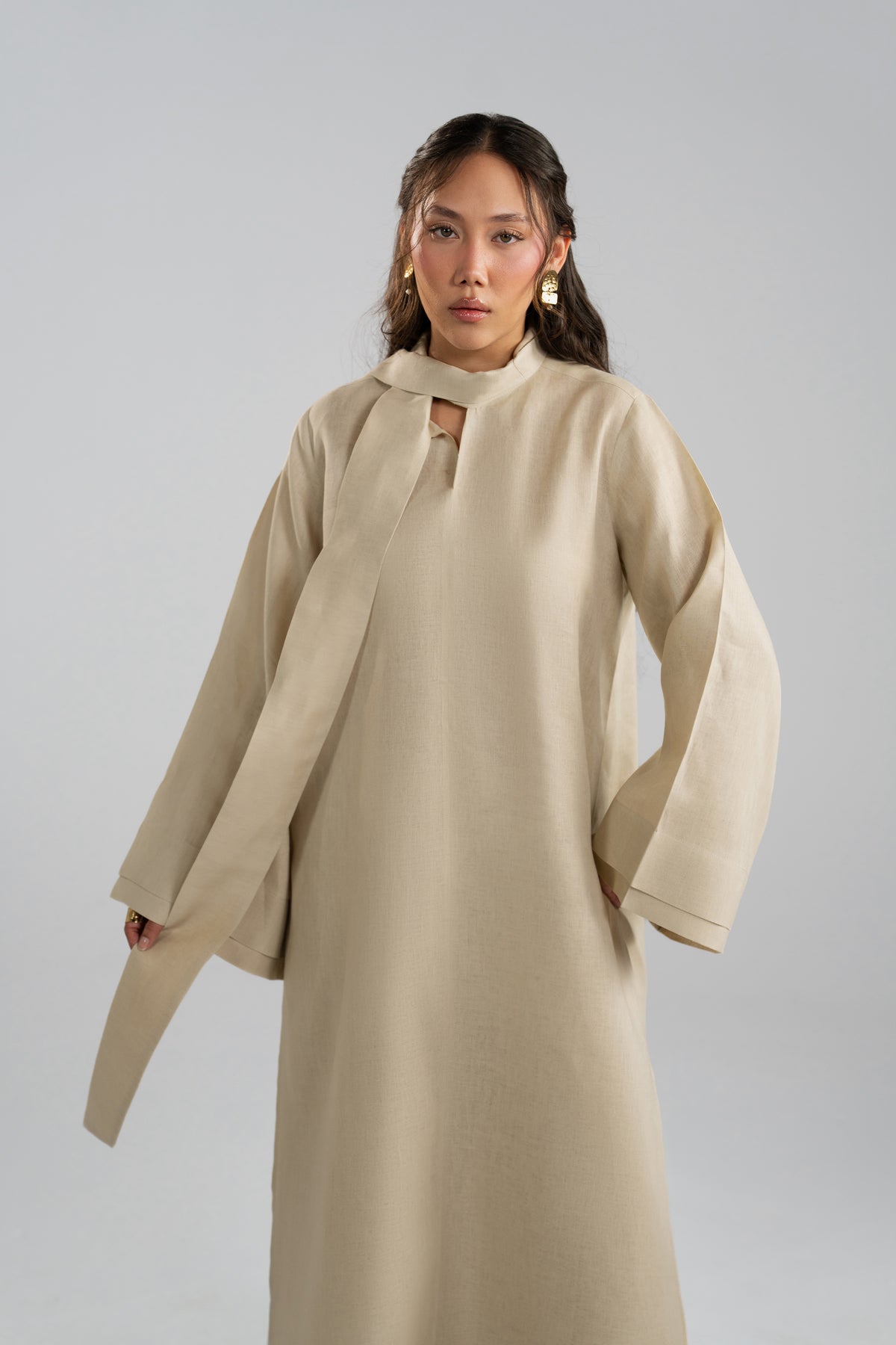 Close-up front view of the linen co-ord's slit neckline and centre-seam tunic styling