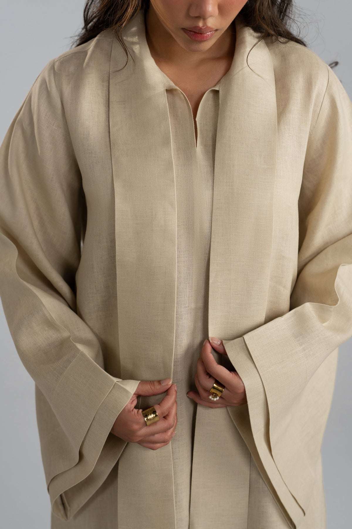 Close-up view of the Sahara Set tunic’s slit neckline and attached linen scarf, highlighting the gold ring detail.