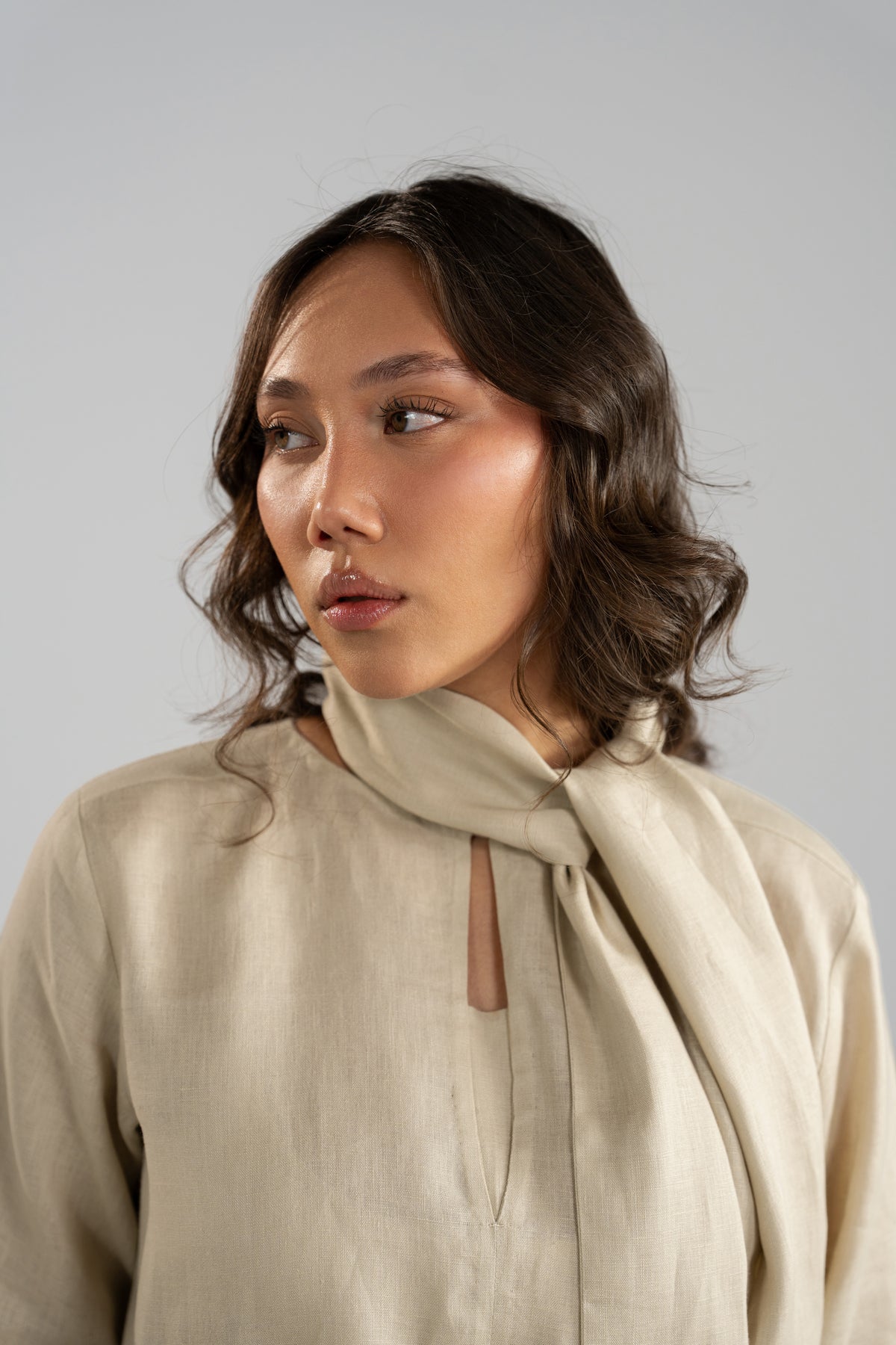 Close-up portrait of Tuscany pure linen top, showing the keyhole neck slit and matching wrapped scarf.